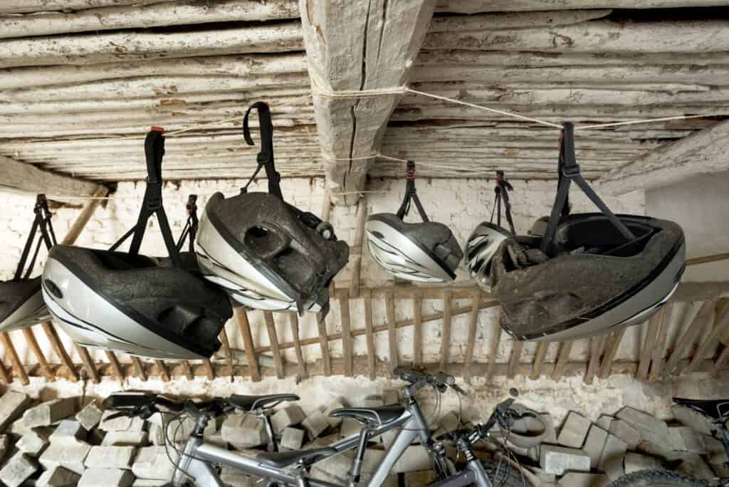 55305,Bicycle helmets hanging from wooden ceiling
